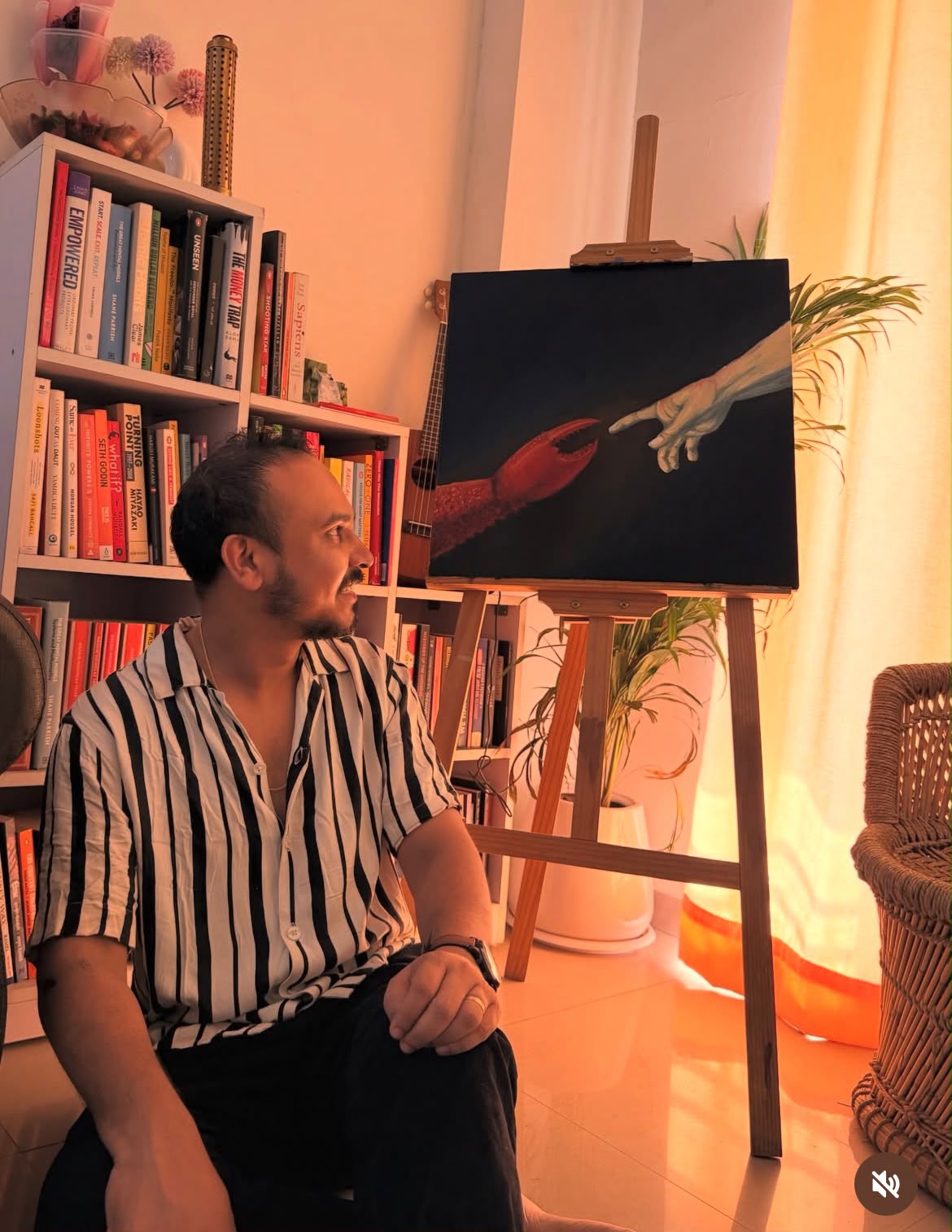 the painting on an easel beside a bookshelf, evening light